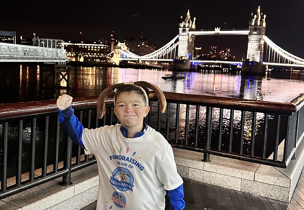 Barney Thomas in front of Tower Bridge during his nighttime fundraising trek through London