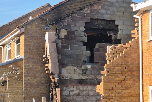 A hole blown in the wall of the Cainey family home by the gas explosion